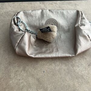 One Pair of Kipling Pouches in Gold with Gorilla  excellent used condition.